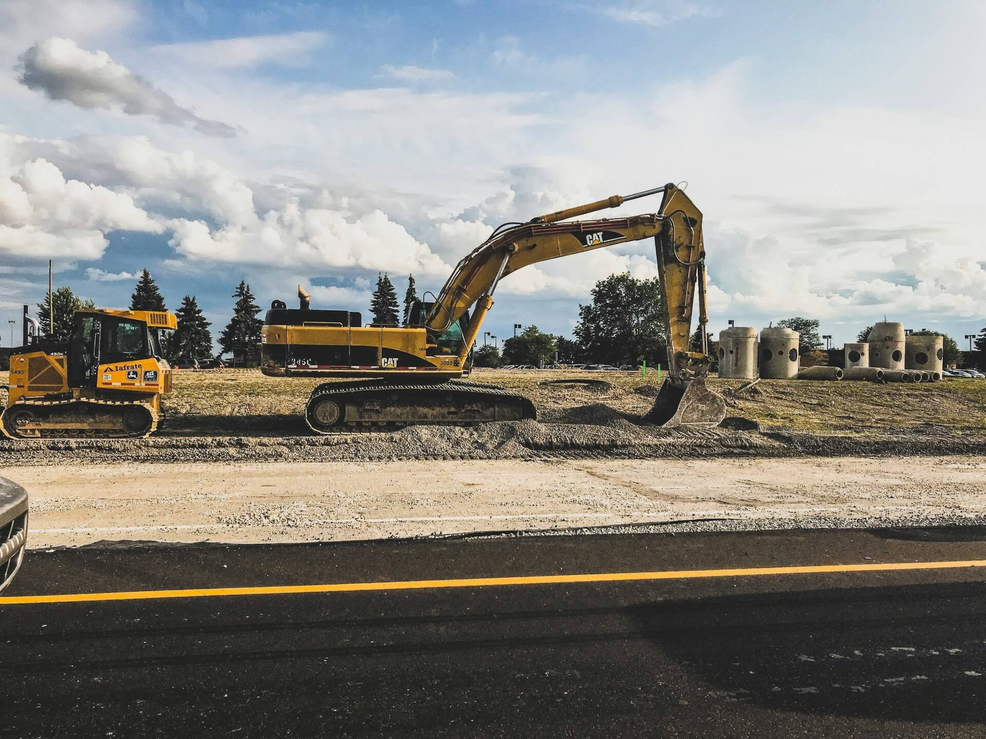Excavator working at a landscape construction site